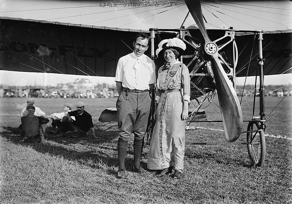 Earle Ovington and wife standing in front of airplane