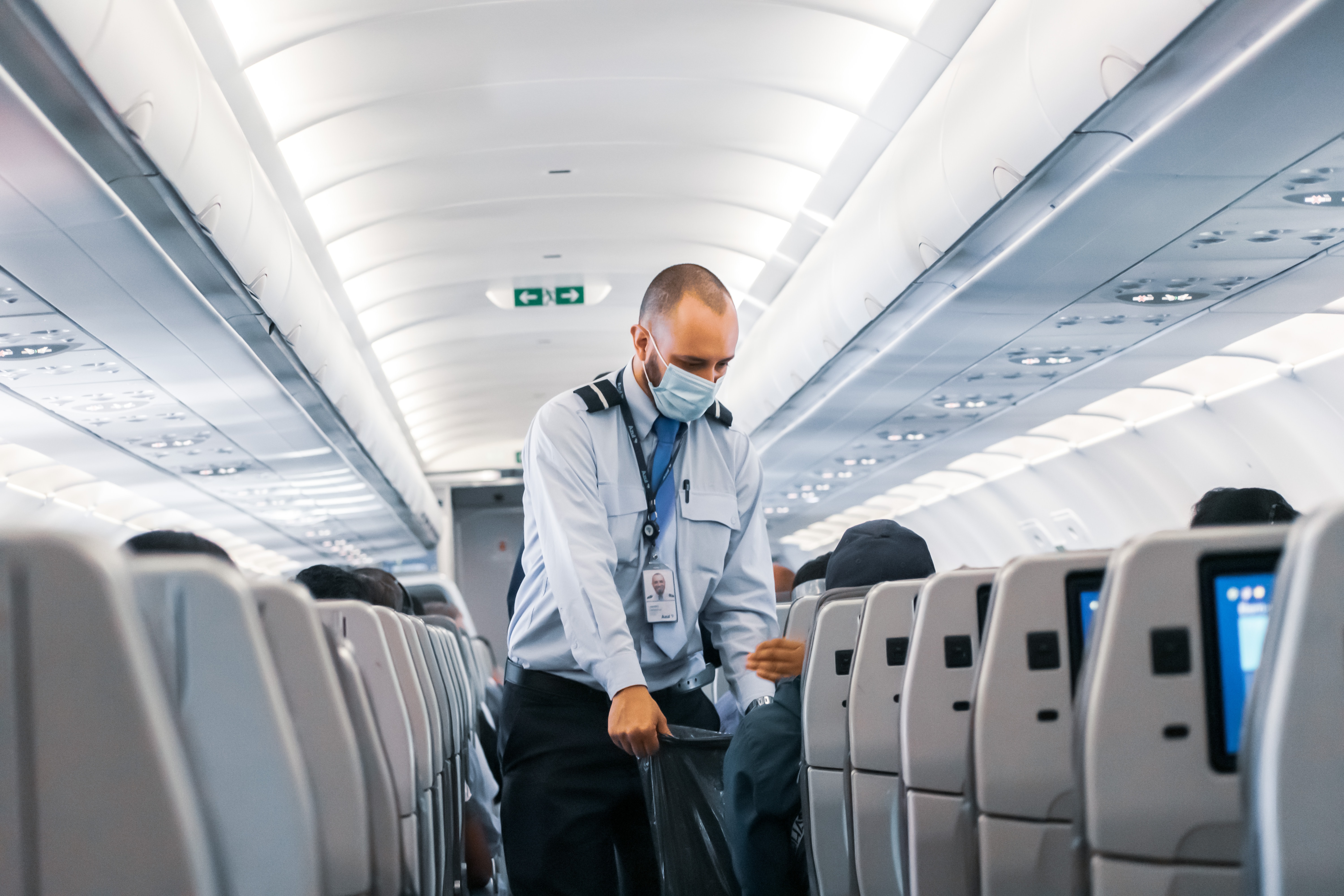 Flight attendant wearing a mask