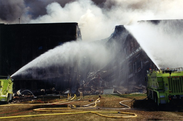 Fire crews put out the fire at the Pentagon after it is struck by an aircraft