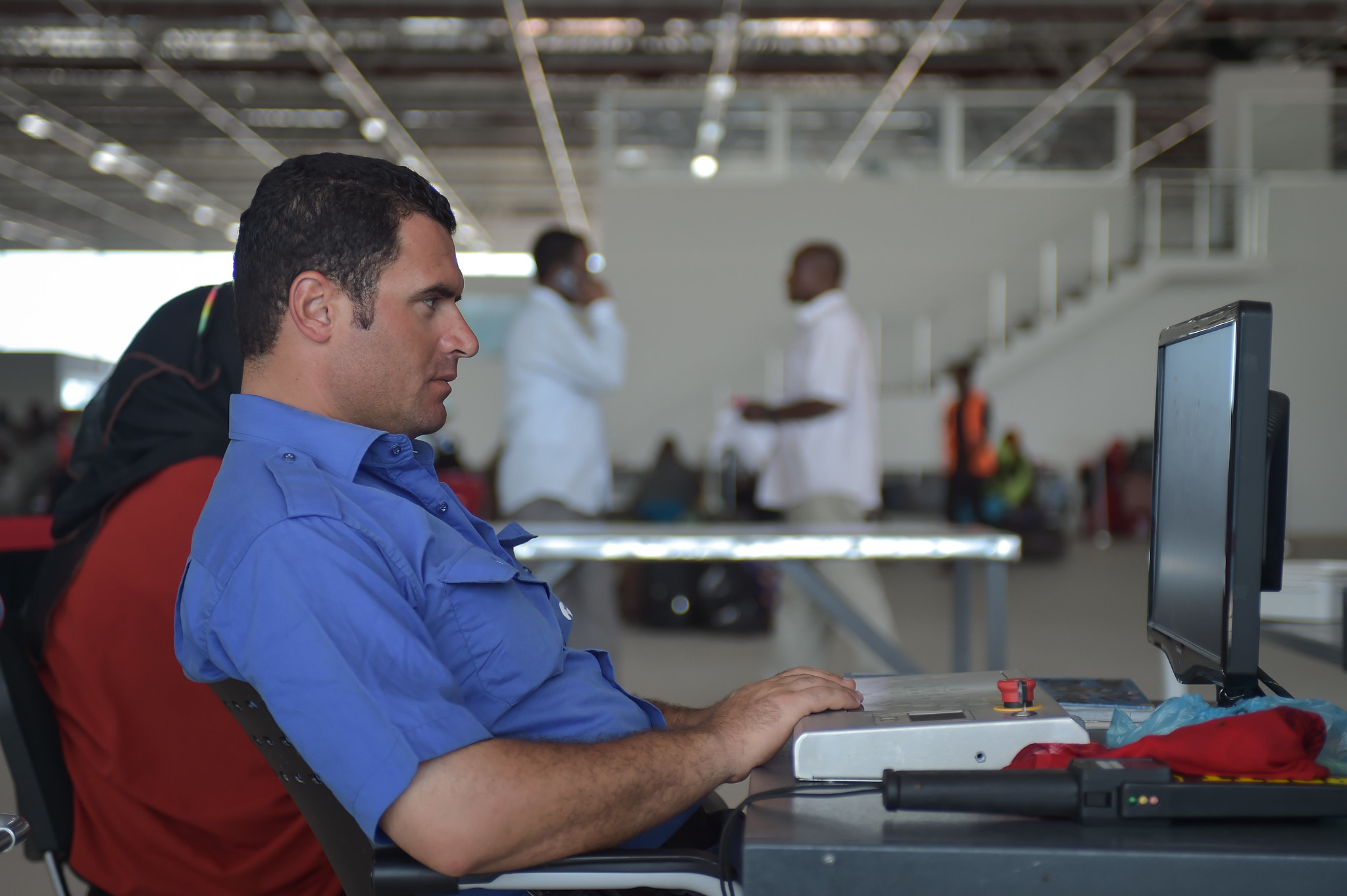 Airport security officer watching an x-ray monitor